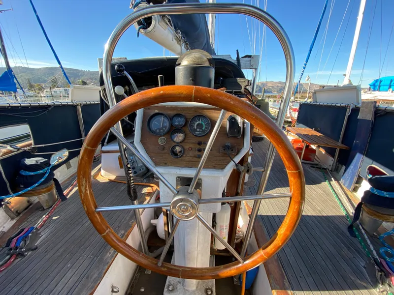 Slide: The Image of 1979 CT 48 sailboat helm with wooden wheel and navigation instruments. - 10