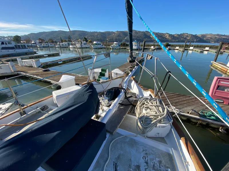 Slide: The Image of 1979 CT 48 sailboat docked at marina with clear blue sky and mountains. - 12