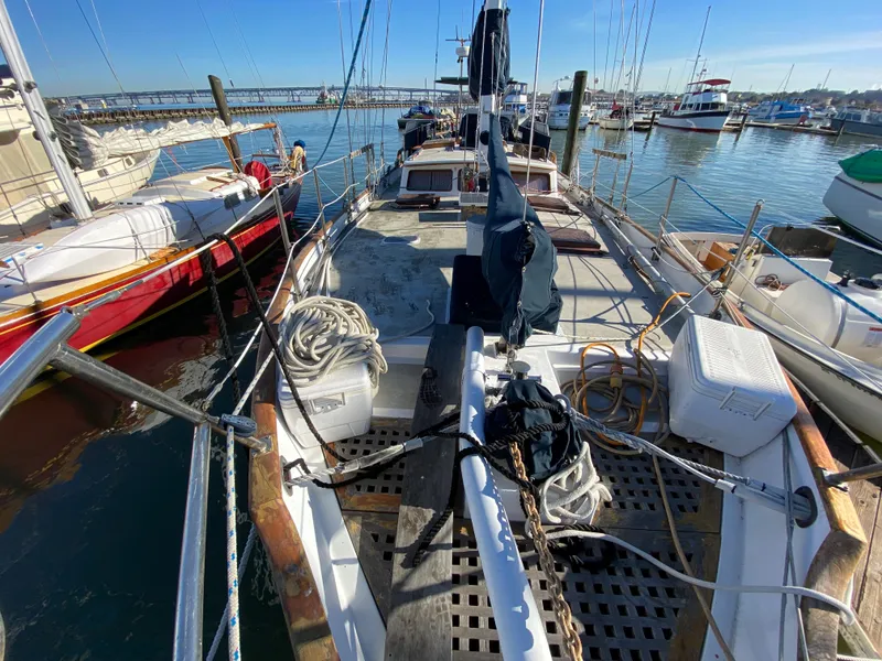 Slide: The Image of 1979 CT 48 sailboat docked in marina, surrounded by other boats, clear sky. - 13