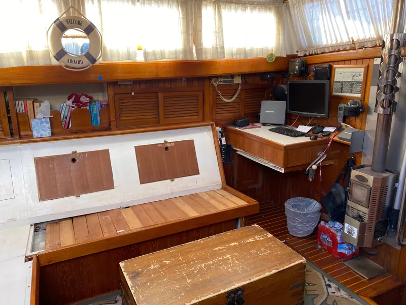 Slide: The Image of Cozy 1979 CT 48 boat interior with wooden furnishings and a compact workspace. - 18