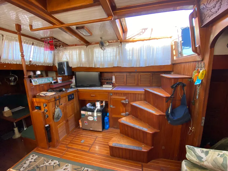 Slide: The Image of Interior of a 1979 CT 48 boat with wooden decor and staircase. - 19