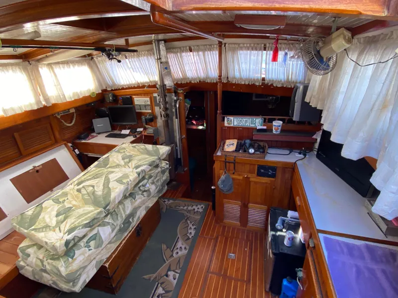 Slide: The Image of Interior of a 1979 CT 48 boat with cozy wooden furnishings and nautical decor. - 20