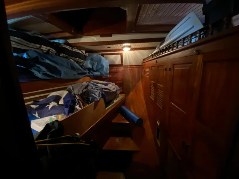 Slide: The Image of 1979 CT 48 yacht interior with wooden cabinets and cozy sleeping area. - 26