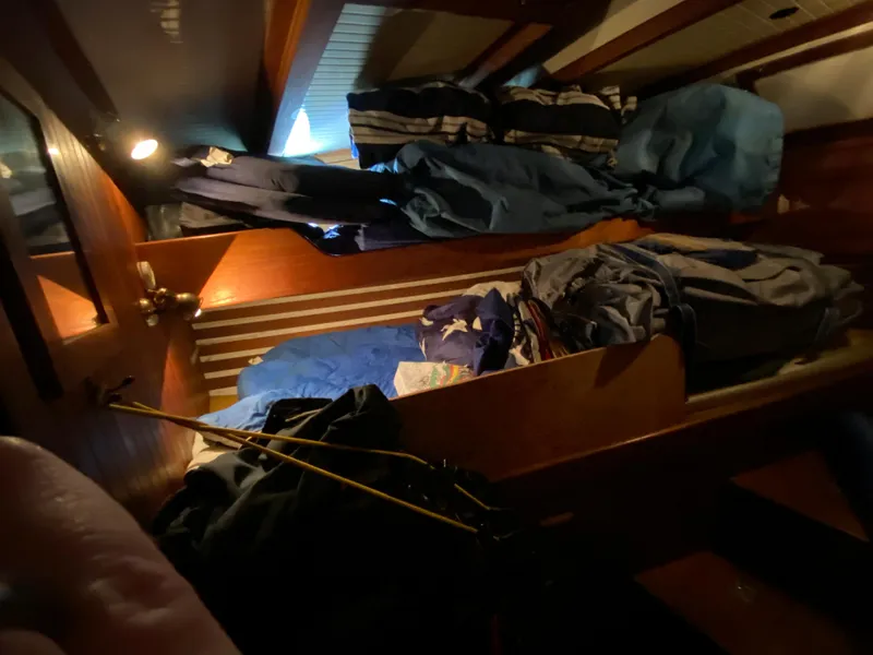 Slide: The Image of Cozy cabin interior with wooden accents and neatly stacked bedding, CT 48 model, 1979. - 27