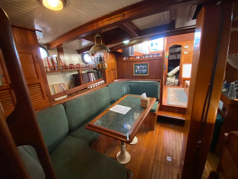 Slide: The Image of 1979 CT 48 yacht interior with wooden decor and green seating area. - 30