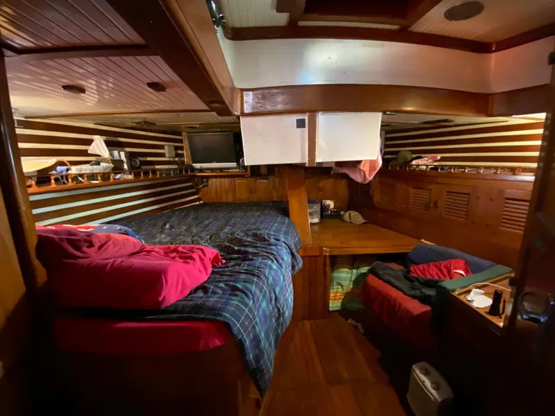 Slide: The Image of Cozy 1979 CT 48 yacht cabin with wooden interior and striped walls. - 33