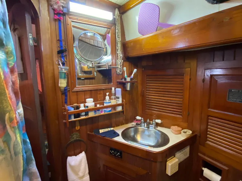 Slide: The Image of Vintage 1979 CT 48 yacht bathroom with wooden cabinetry and stainless steel sink. - 38