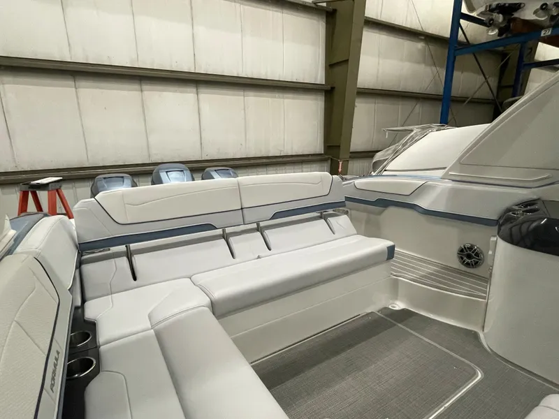 Slide: The Image of 2022 Formula 350 Crossover Bowrider interior seating in a storage facility. - 20