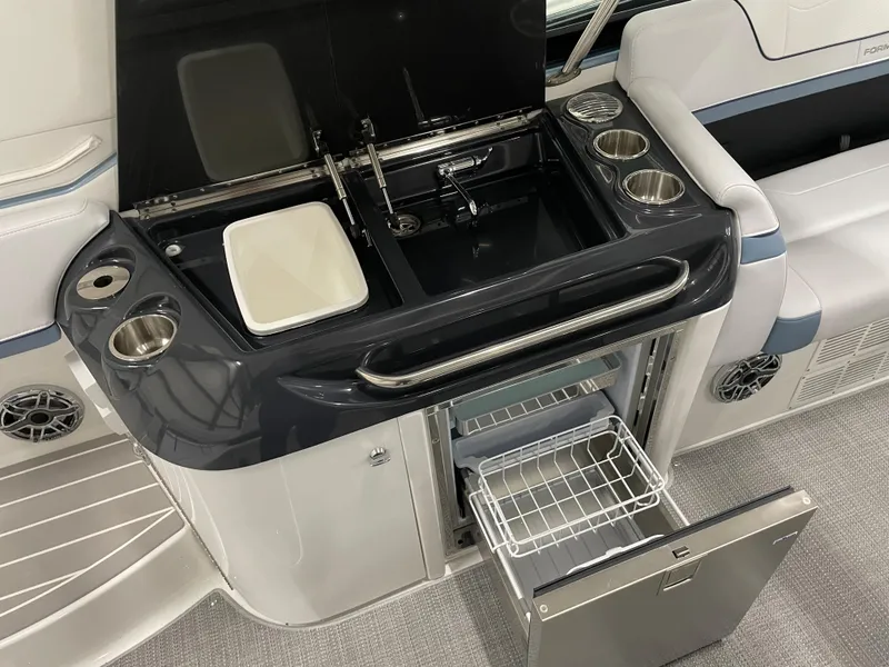 Slide: The Image of 2022 Formula 350 Crossover Bowrider kitchenette with sink, storage, and mini-fridge. - 26