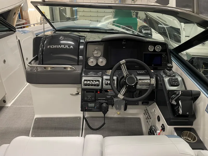 Slide: The Image of 2022 Formula 350 Crossover Bowrider helm with modern controls and navigation equipment. - 29