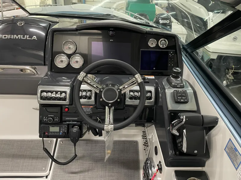 Slide: The Image of 2022 Formula 350 Crossover Bowrider helm with advanced navigation controls and gauges. - 30