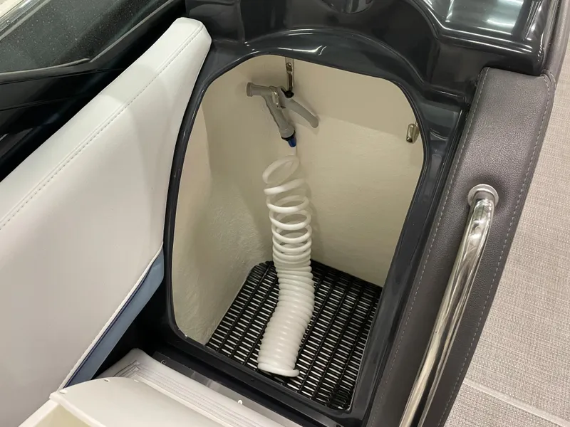 Slide: The Image of 2022 Formula 350 Crossover Bowrider storage compartment with coiled hose. - 33