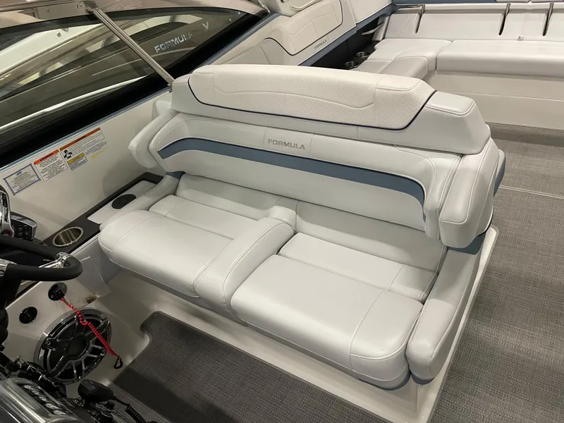 Slide: The Image of 2022 Formula 350 Crossover Bowrider interior seating area with white and blue upholstery. - 34