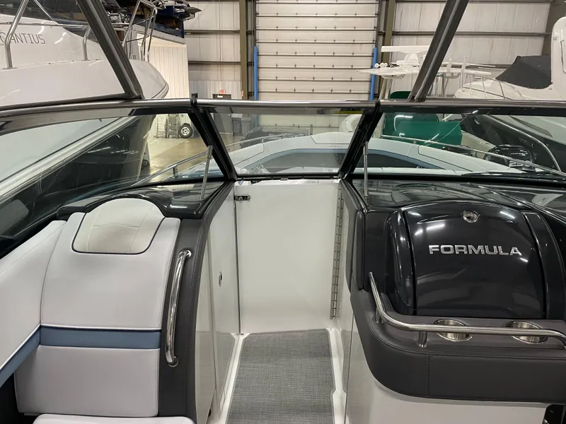 Slide: The Image of 2022 Formula 350 Crossover Bowrider interior view in a boat storage facility. - 36