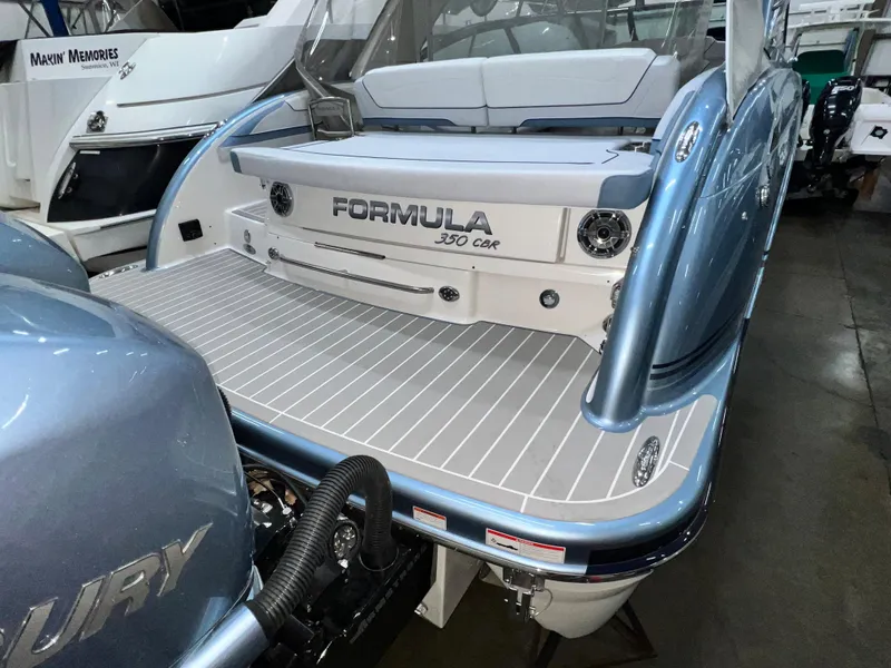 Slide: The Image of 2022 Formula 350 Crossover Bowrider boat, rear view, in a showroom. - 8