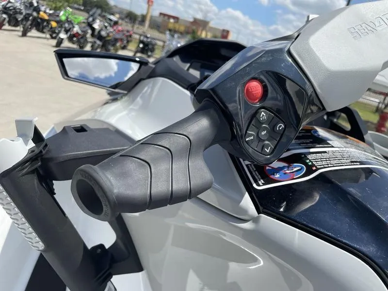 Slide: The Image of Close-up of 2022 Sea-Doo FISH PRO handlebar controls, showcasing buttons and grip design. - 3