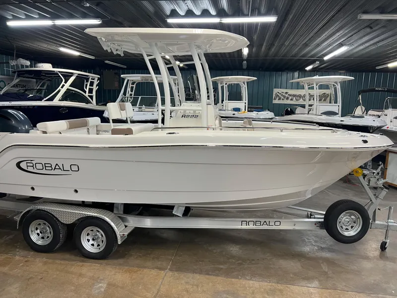 The Image of 2023 Robalo R222 Center Console boat on trailer in showroom. - 0