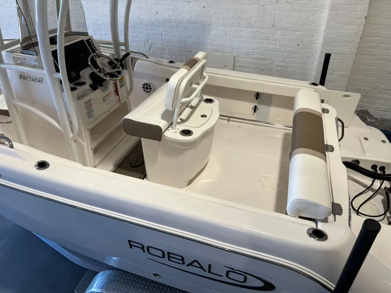 Slide: The Image of 2023 Robalo R222 Center Console boat interior with seating and steering console. - 10