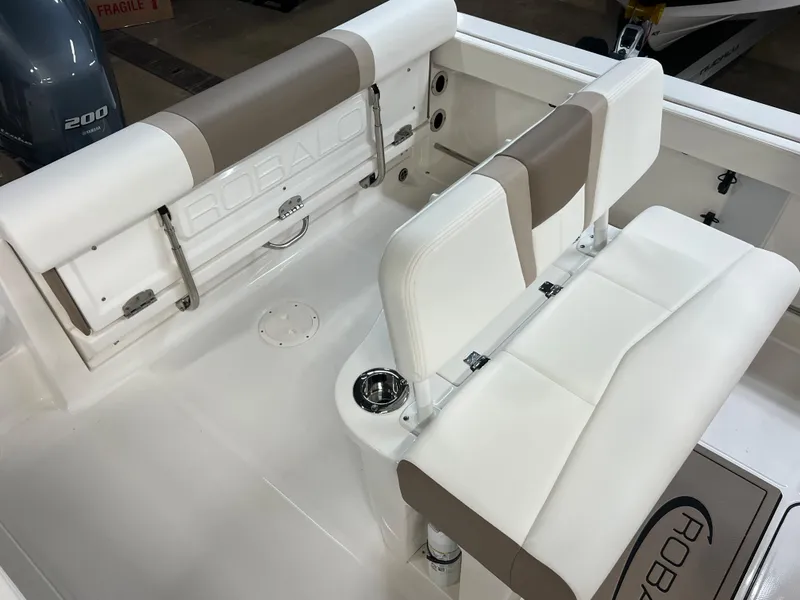 Slide: The Image of 2023 Robalo R222 Center Console boat interior with white and beige seating. - 14