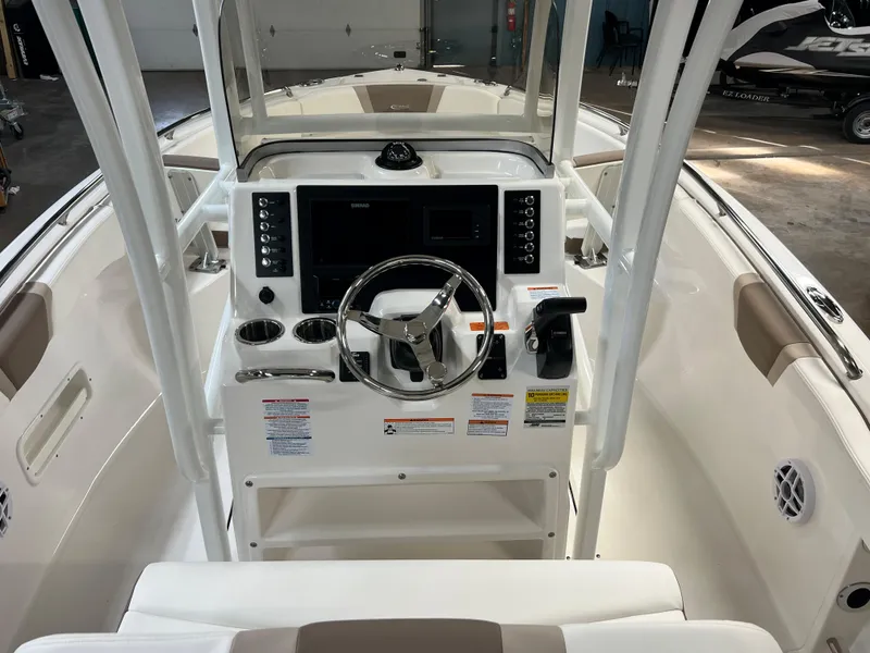 Slide: The Image of 2023 Robalo R222 Center Console boat interior with steering wheel and control panel. - 15