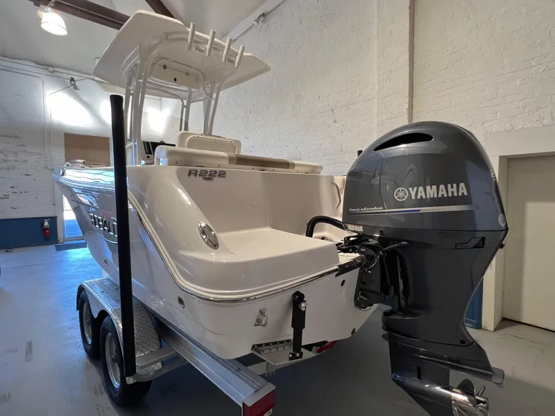 Slide: The Image of 2023 Robalo R222 Center Console boat with Yamaha outboard motor in a garage. - 3
