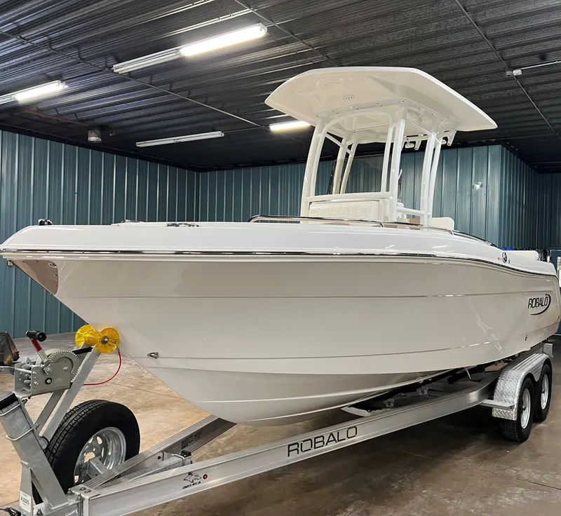 Slide: The Image of 2023 Robalo R222 Center Console boat on trailer in indoor storage. - 6