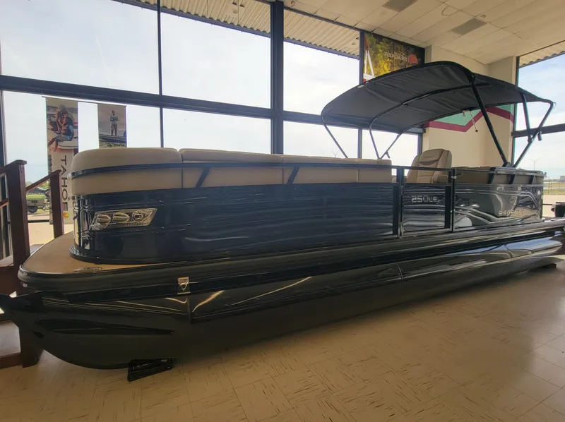 Slide: The Image of 2023 Regency 250 LE3 pontoon boat displayed indoors. - 0
