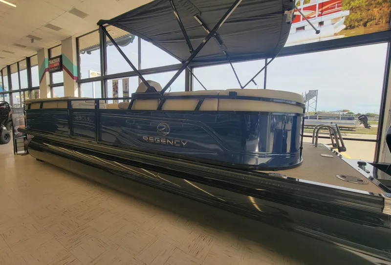 Slide: The Image of 2023 Regency 250 LE3 pontoon boat displayed indoors. - 1