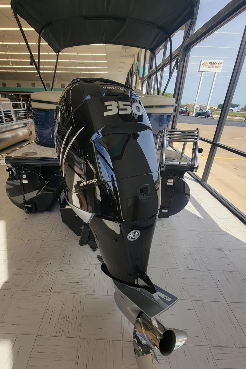 Slide: The Image of 2023 Regency 250 LE3 boat with a powerful 350 engine displayed indoors. - 2