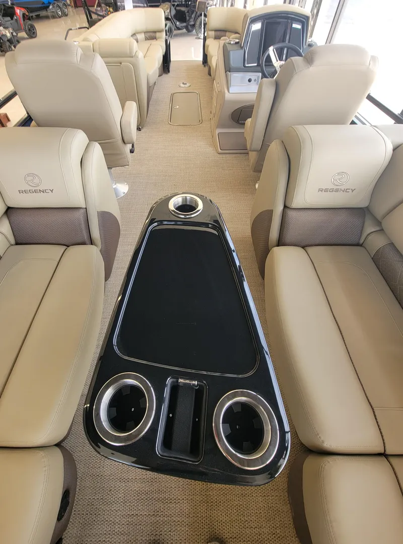 Slide: The Image of 2023 Regency 250 LE3 boat interior with beige seating and black center console. - 4