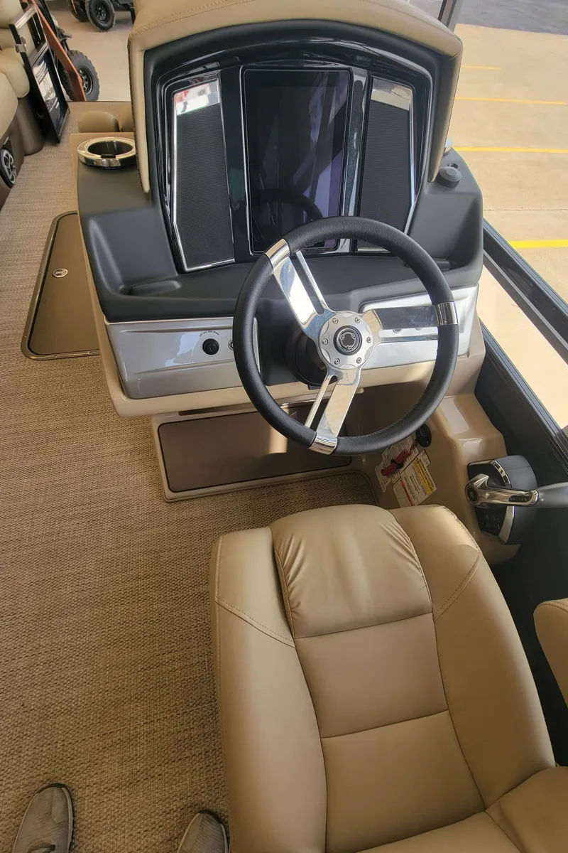 Slide: The Image of 2023 Regency 250 LE3 boat interior with steering wheel and dashboard. - 5