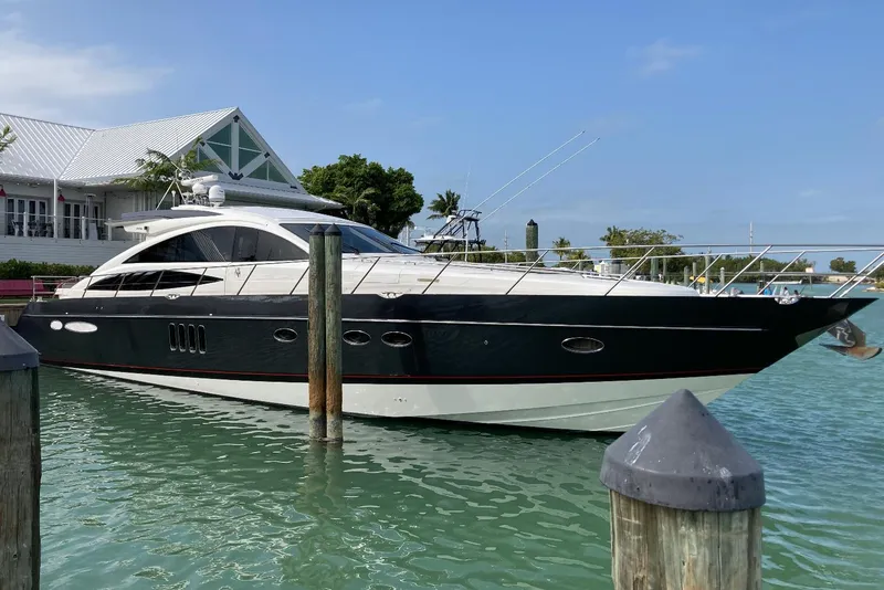 The Image of 2006 Princess V70 yacht docked in marina, clear sky, calm water. - 0