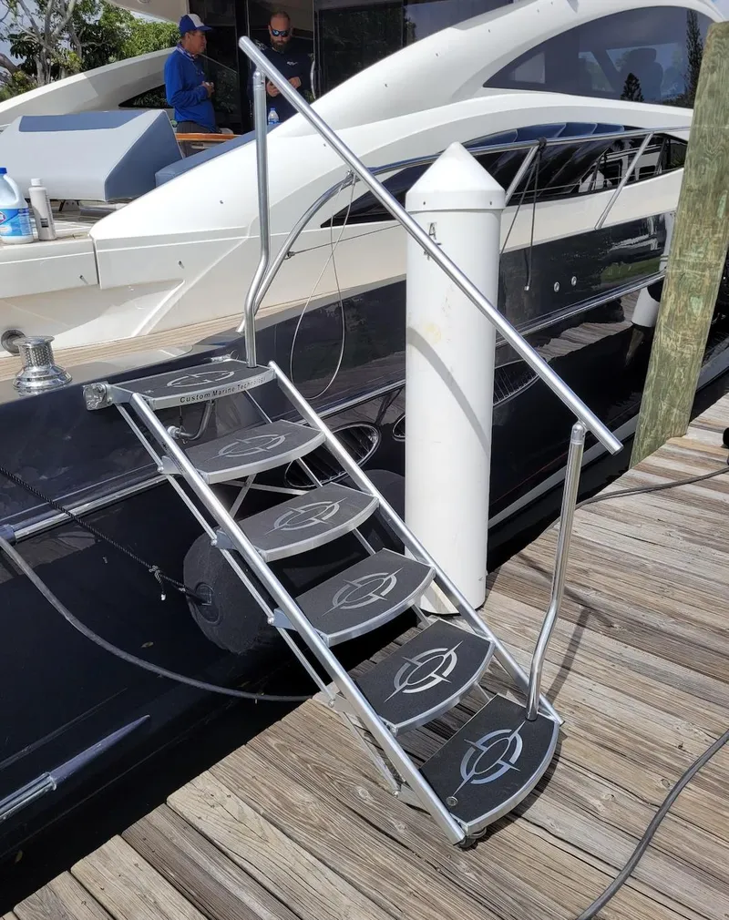 Slide: The Image of Staircase leading to a 2006 Princess V70 yacht docked at a marina. - 12