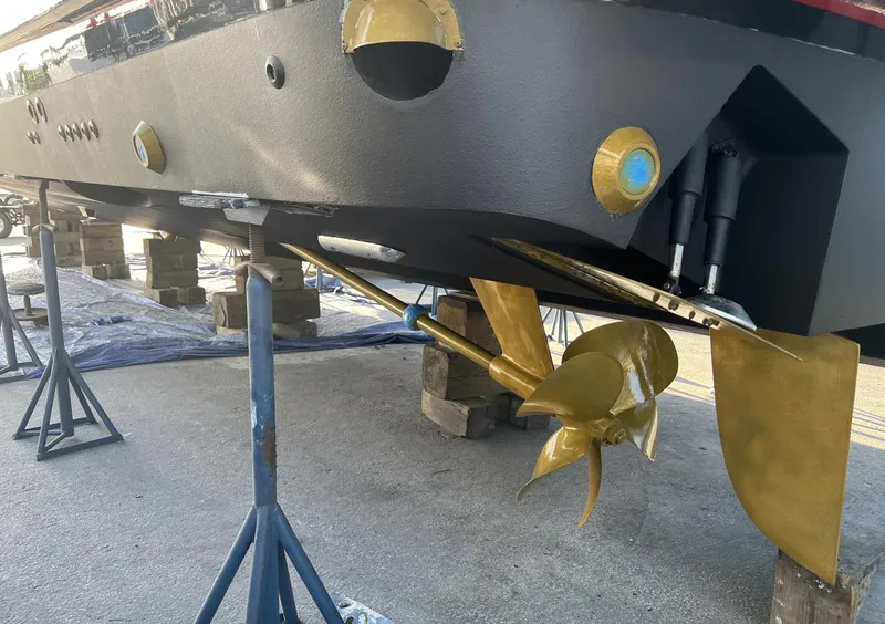 Slide: The Image of 2006 Princess V70 yacht under maintenance, showcasing propeller and rudder details. - 18