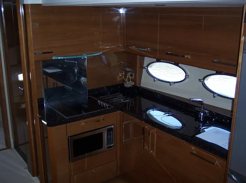 Slide: The Image of Luxurious kitchen interior of 2006 Princess V70 yacht with wood cabinetry and modern appliances. - 20