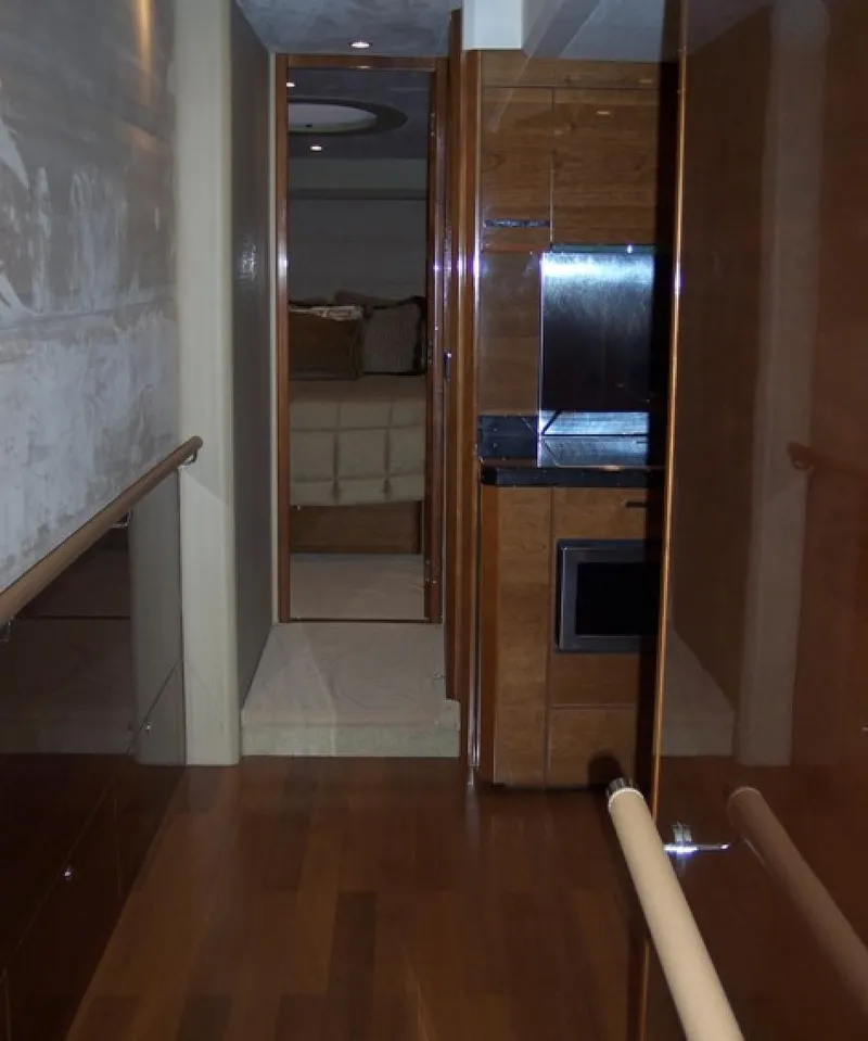Slide: The Image of Interior hallway of a 2006 Princess V70 yacht with wood paneling and modern design. - 22