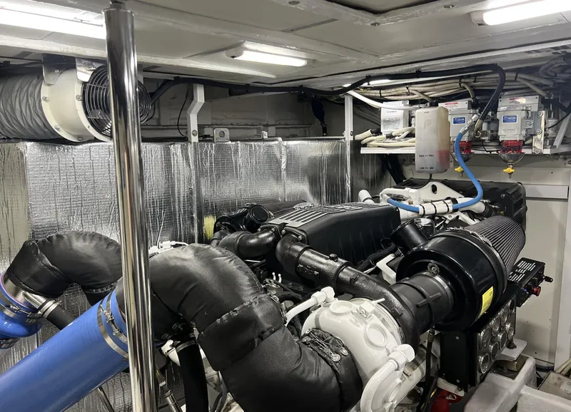 Slide: The Image of Engine room of a 2006 Princess V70 yacht, featuring modern equipment and insulation. - 28