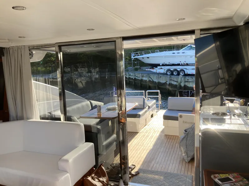 Slide: The Image of Luxurious 2006 Princess V70 yacht interior with elegant seating and outdoor view. - 3