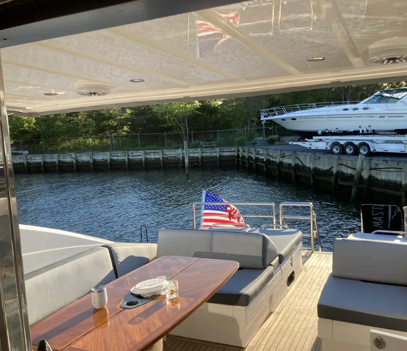 Slide: The Image of Luxury yacht deck with seating, table, and American flag; Princess V70, 2006 model. - 5