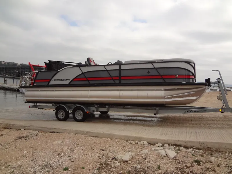 Slide: The Image of 2023 Berkshire 25UL STS 3.0+ pontoon boat on trailer by the shore. - 10