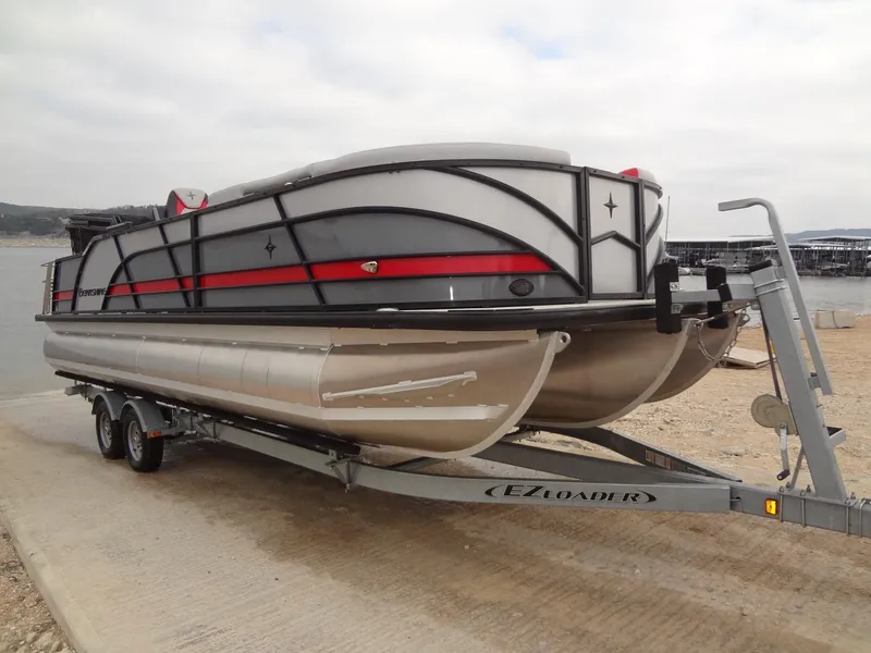 Slide: The Image of 2023 Berkshire 25UL STS 3.0+ pontoon boat on trailer at lakeside. - 11