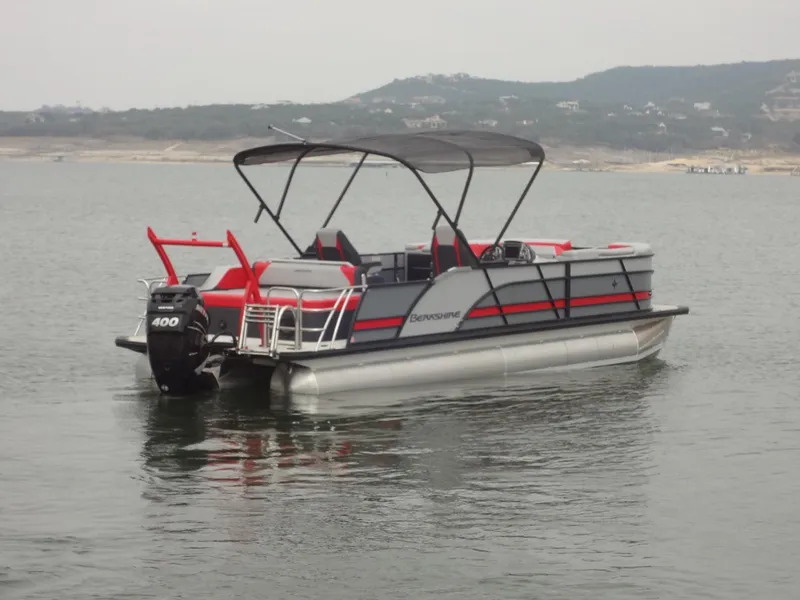 Slide: The Image of 2023 Berkshire 25UL STS 3.0+ pontoon boat on calm water. - 2