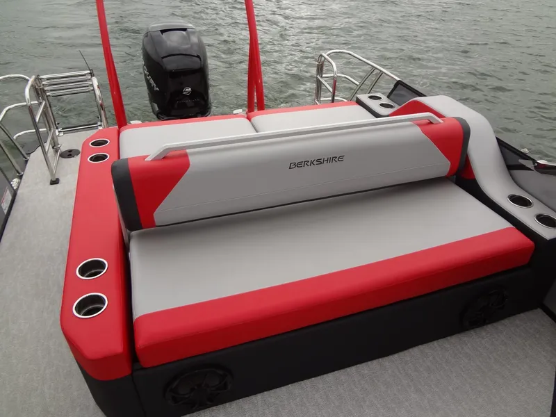 Slide: The Image of 2023 Berkshire 25UL STS 3.0+ boat with red and gray seating, on water. - 25