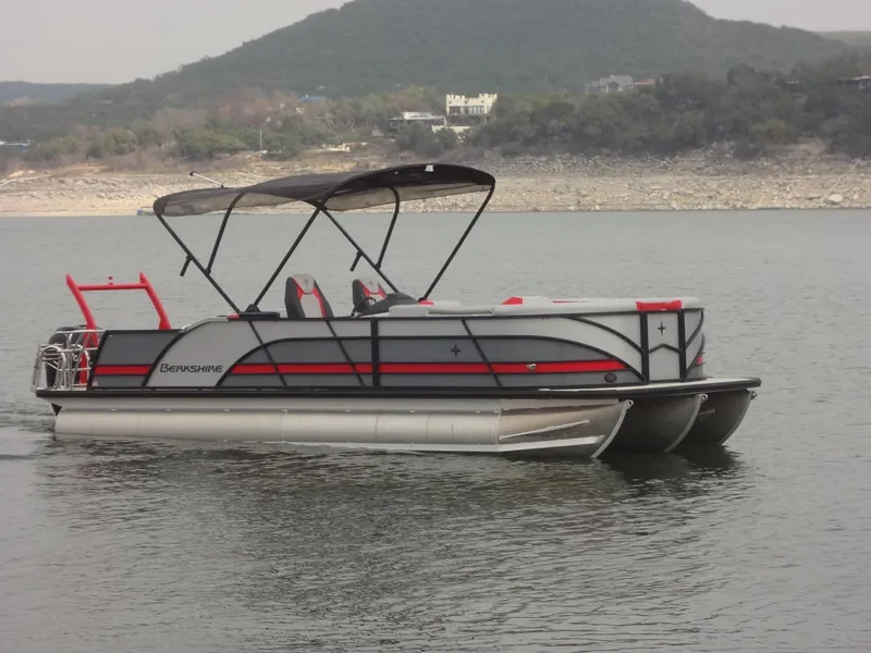 Slide: The Image of 2023 Berkshire 25UL STS 3.0+ pontoon boat on a calm lake. - 3