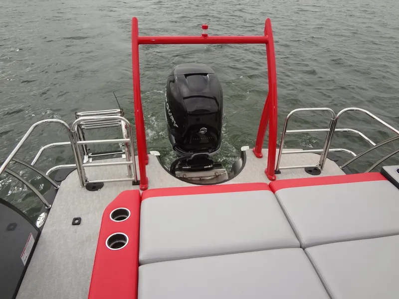 Slide: The Image of 2023 Berkshire 25UL STS 3.0+ pontoon boat with red accents and outboard motor on water. - 32