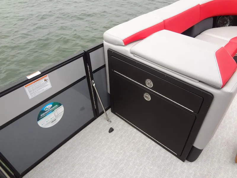 Slide: The Image of 2023 Berkshire 25UL STS 3.0+ boat interior with seating and storage, on water. - 36