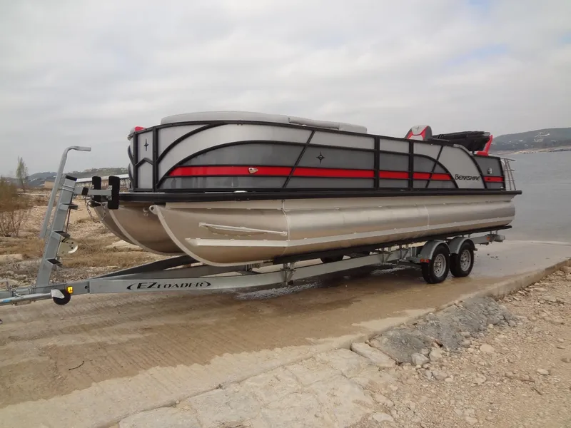 Slide: The Image of 2023 Berkshire 25UL STS 3.0+ pontoon boat on trailer by a lake. - 5
