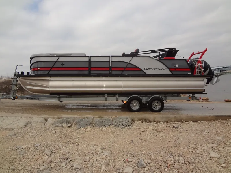 Slide: The Image of 2023 Berkshire 25UL STS 3.0+ pontoon boat on trailer, parked near a lake. - 6