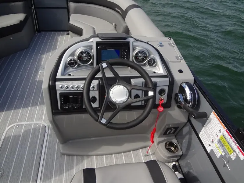 Slide: The Image of 2023 Berkshire 24UL CTS 3.0 boat dashboard with steering wheel and controls. - 18