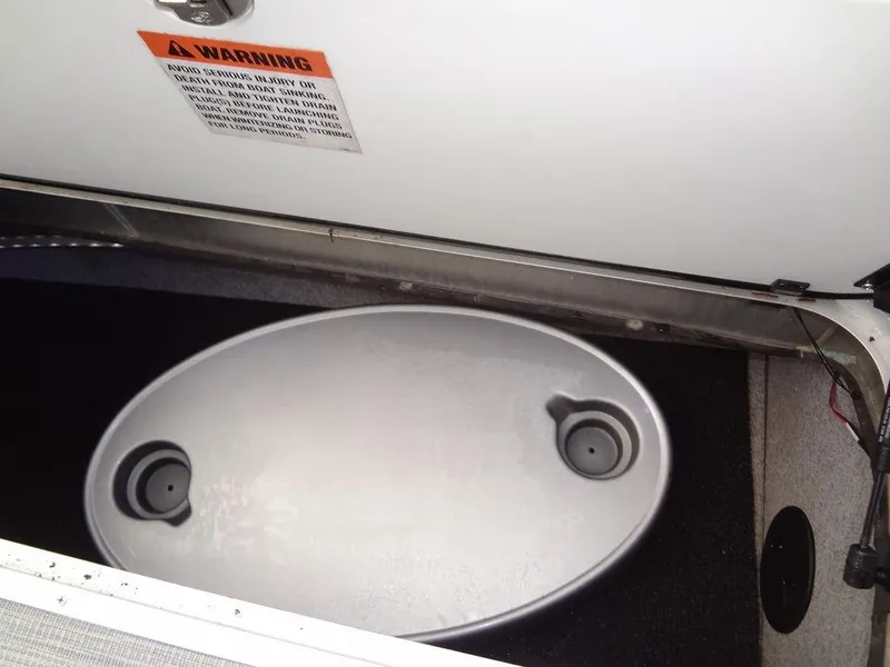 Slide: The Image of Storage compartment in 2023 Berkshire 24UL CTS 3.0 boat with warning label. - 33